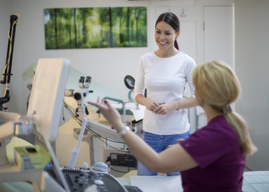 A patient talks through a fallopian tube patency test with a gynaecologist during a consultation at a Reprofit clinic.